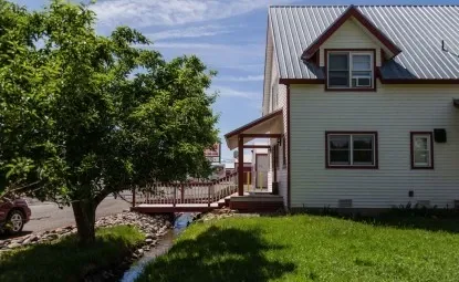 Storage facility front office with tree in front.
