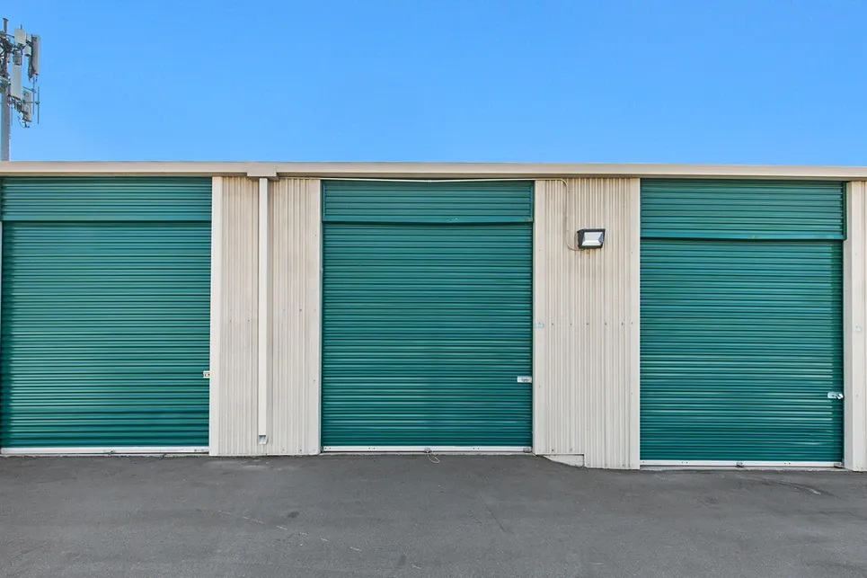 Green tall exterior storage unit doors.