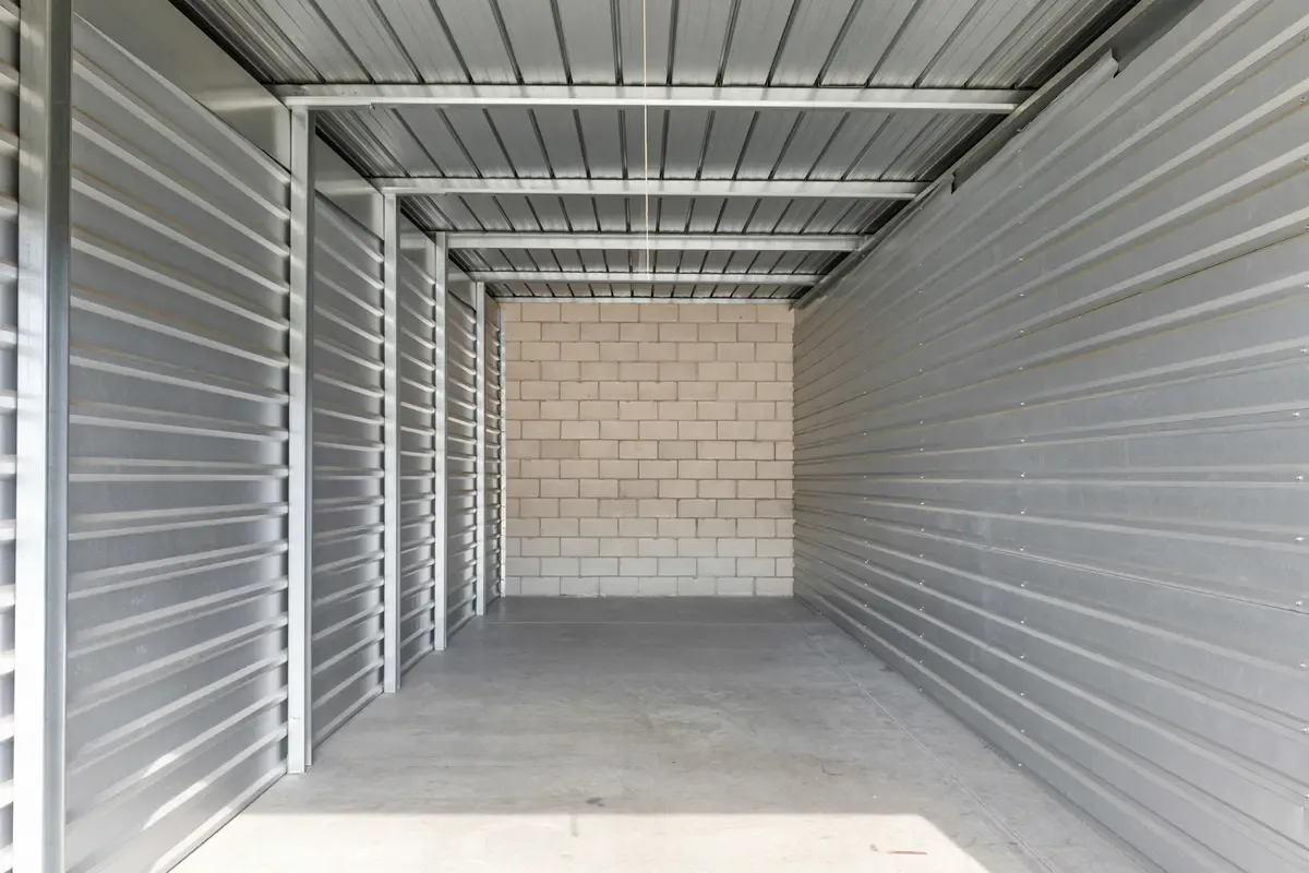 Interior of a storage unit with a concrete wall.