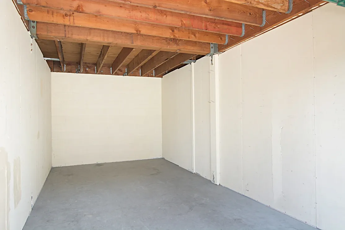 Interior of a white concrete walled storage unit.