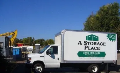A Storage Place branded moving truck in front of the main gate.