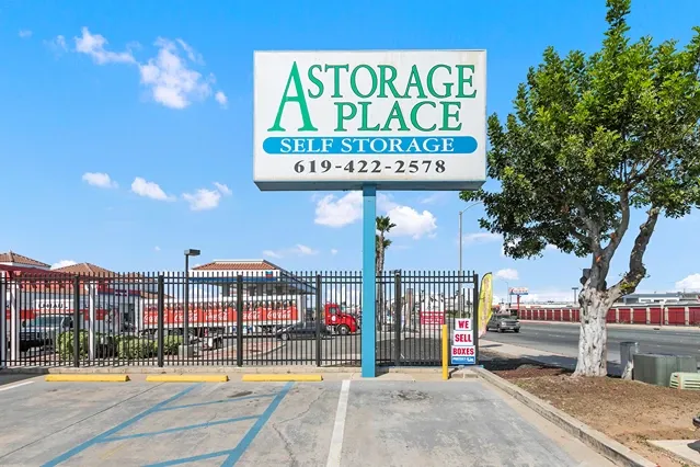 A Storage Place street sign with road behind it.