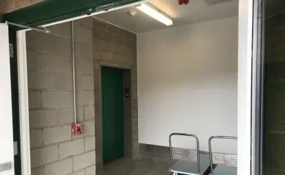 Elevator and dollies at an indoor storage facility.