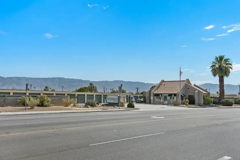 Flag, main gate, and office of a storage facility.