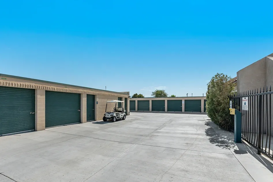 A storage place moving truck near the front gate and sign of a facility.