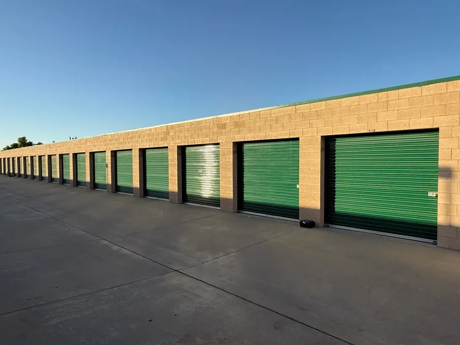Green storage units at sunset.