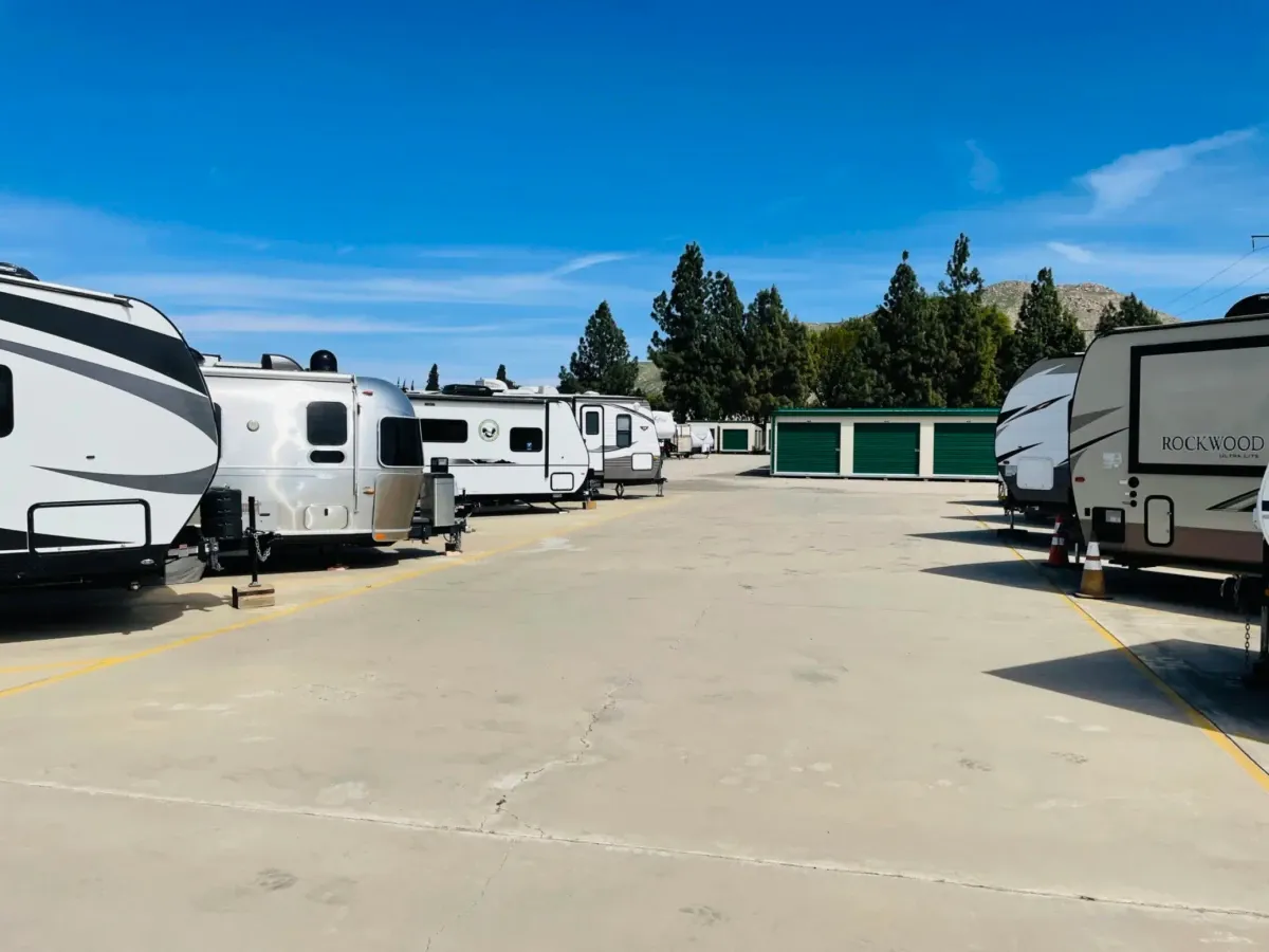 Small outdoor storage units with green doors.