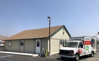 Uhaul truck next to an outdoor storage office.